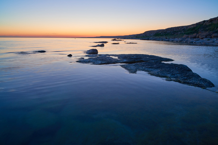 Coast of the sea at sunset. On the shore of the Caspian Sea. The Caspian Sea is the enclosed water body on Earth by area.の写真素材