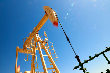 Oil pump are working in the blue sky background. blur effect. World Oil Industry. Western region of...