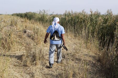 Hunting man with a gun looking for a beastの写真素材
