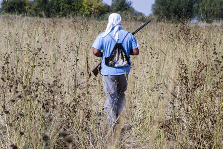 Hunting man with a gun looking for a beastの写真素材