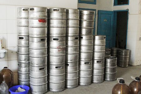 Metal beer kegs in a workshop warehouseの写真素材