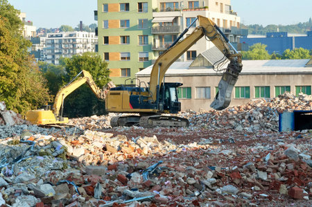 Demolition of an old building with a large excavator in the foreground