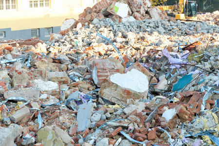 Pile of rubble and debris from a demolition site with excavatorの写真素材