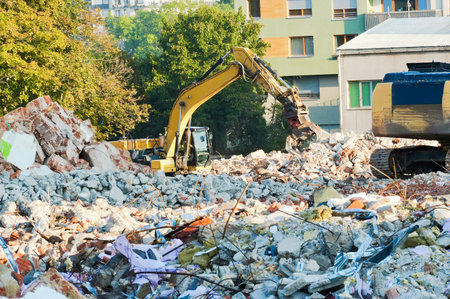 Demolition site with excavator and other garbage in the city.の写真素材