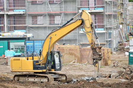 excavator at a construction site on a background of building under construction