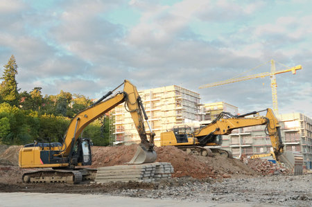 excavator at a construction site on a background of multi-storey buildings