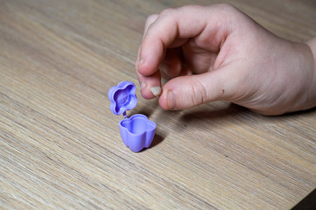 Hands of a child making a mold from plasticine.