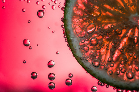 Lime underwater with bubbles and color background.