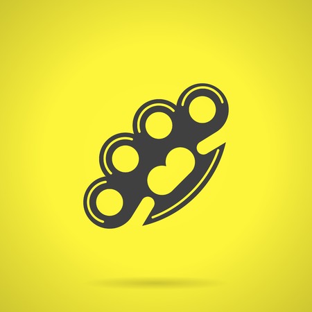 Flat black silhouette vector icon for brass knuckles weapon for self-defense on yellow background.のイラスト素材