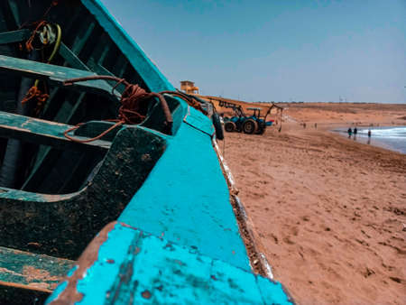 A traditional fishing boat moored on the beach.の写真素材