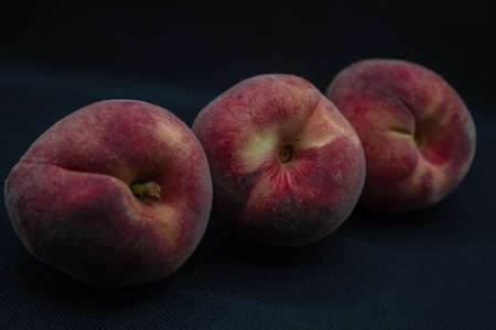 Red peach on a black background