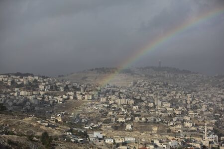 Rainbow on a view of old city of Jerusalem and villages around Jerusalem