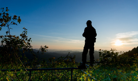 silhouette a man with Tree marigold with Tung Bua Tong background  in Maehongson, Thailandの写真素材