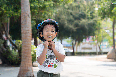 Happy child wearing a bike helmet outdoorsの写真素材
