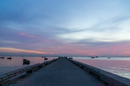 Sunset sky with port and  silhouette of small fishing boats.の写真素材