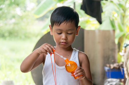 Asian boy playing with soap bubbles, Boy with Bubblesの写真素材