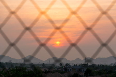 steel grate with sunset sky backgroundの写真素材