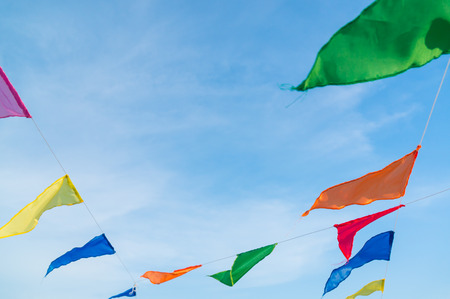 multicolored flags against the blue skyの写真素材