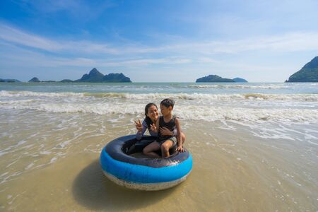 Prachuap Khiri Khan province, Thailand  - December 30, 2017 : Family having fun outdoors play in the sea at ao manao prachuap khiri khan,  Prachuap Khiri Khan province, Thailand.のeditorial素材