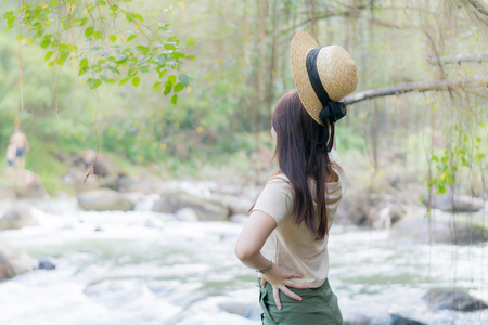 teen girl standing near waterfallの写真素材