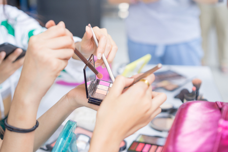 Hands of group girls holding makeup brush and palette for makeup,Beauty conceptの写真素材