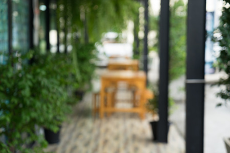 blur of table and chair  against tree in the coffee shopの写真素材