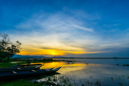 small fishing boat inside the Bang Phra Reservoir in sunrise, Sriracha, Chonburi, Thailandの写真素材