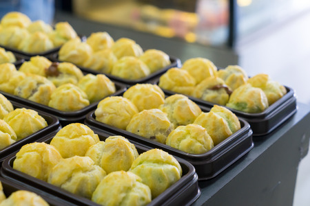 Choux cream in bakery tray on table.の写真素材