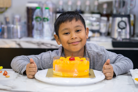 happy kid boy making a cakeの写真素材