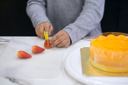 hand of asia kid boy making a cakeの写真素材