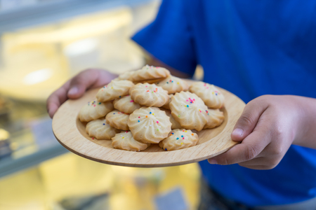 Pile of cookies on wooden plateの写真素材