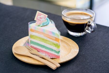 rainbow cake on wooden plateの写真素材