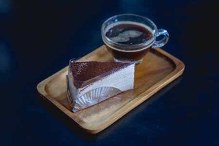 chocolate cake crepes with coffee on a wooden plateの写真素材