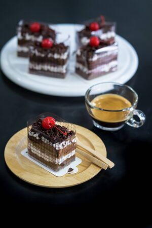 Black Forest, Chocolate cake on wooden dish with black backgroundの写真素材