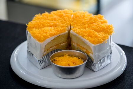 Gold Egg Yolk Thread Cakes on wooden plateの写真素材