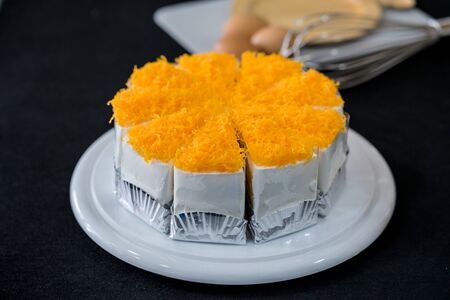 Gold Egg Yolk Thread Cakes on wooden plateの写真素材