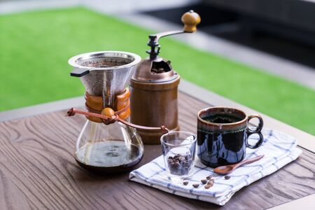 Coffee drip equipment set on wooden table.の写真素材