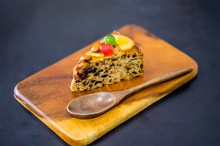delicious sliced fruit cake with mixed fruit  on grate and fubricの写真素材
