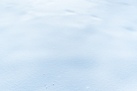 Snow background - Close-up image with the surface of a snow layer, with great details and perfect as a winter background.の写真素材