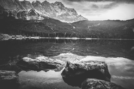 Dramatic scenery with the German Alps mountains reflected in the Eibsee lake. Image depicting tranquility and meditation.の写真素材