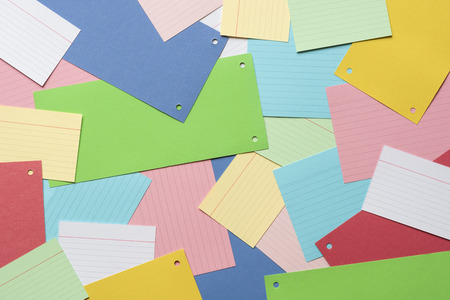 Vibrant background with a multitude of paper notes spread on an office desk