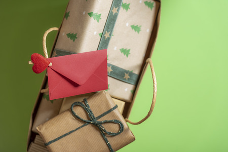 Directly above view with small red envelope clipped with a heart-shaped clip on the bag handle....