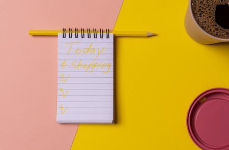 To do list for today with only the word shopping on the notebook. Management concept with the daily...