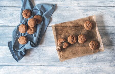 Top view of rye bread rolls on baking paper and on a kitchen towel, on a white table. Rye buns, fresh from the oven. Flat lay of healthy basic food.の写真素材