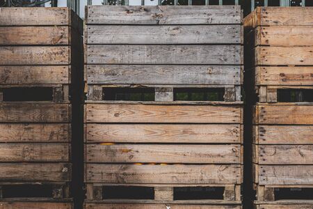 Commercial wooden boxes for storing fruits and vegetables. Merchandise wooden containers in outdoor storage space. Warehouse with wooden crates.の写真素材