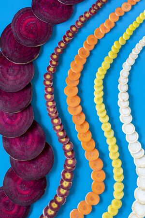 Fresh vegetables sliced on a blue background.の写真素材
