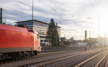 Modern red locomotive traveling on railway tracks. Public transport. Train travel concept. High-speed locomotive near Singen train station, Germany.の写真素材