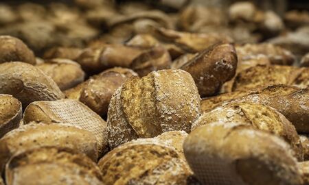 Sourdough bread buns close-up. Many bread rolls. Freshly baked bread. Organic whole-wheat loaves....