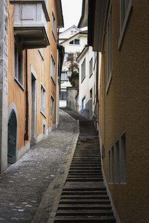 Zurich alley between colorful old buildings in the old city center, Switzerland. Street alley in Zurich city. A stairway on a path between buildings.の写真素材