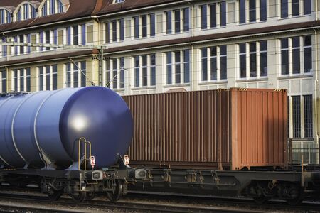 Freight train wagons on railroad tracks, in Singen train station, Germany, in sunset light. Close-up...